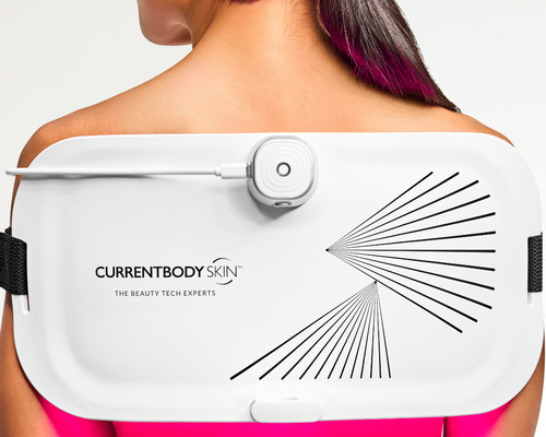 CurrentBody LED Light Therapy Panel on woman's back for pain relief and skin treatment